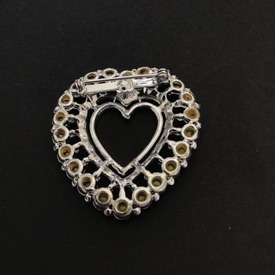 Silver tone heart shaped brooch