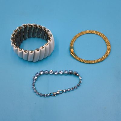 Lot of 3 Bracelets — White Stretch Link, Gold-Tone Textured Bangle, Rhinestone Tennis Bracelet
