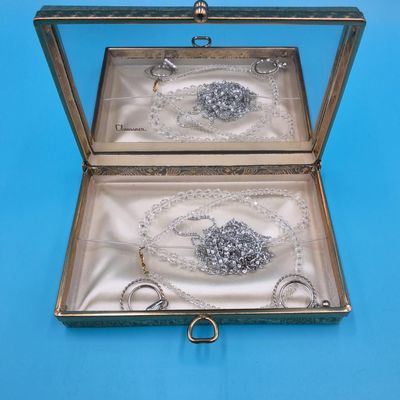 Claussner glass‑mirrored jewelry box with assorted beaded and silver‑tone chains