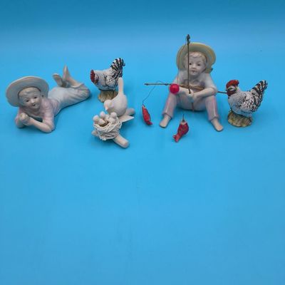 Porcelain figural lot — two children, bird on nest and pair of chickens (approx. 5 pcs)
