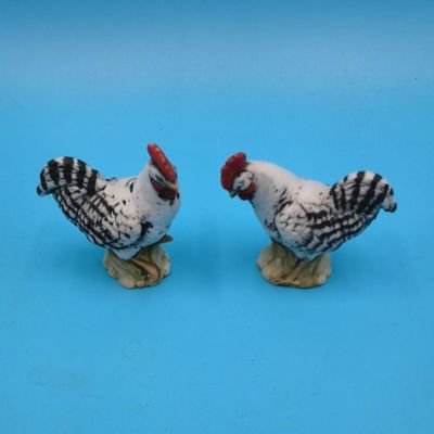 Porcelain figural lot — two children, bird on nest and pair of chickens (approx. 5 pcs)