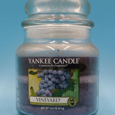 Lot of approximately 11 Yankee Candle glass jar candles — assorted scents & sizes