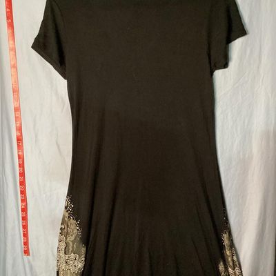 Sale Photo Thumbnail #30: Vocal brand black short sleeve V-neck tunic top or mini dress featuring an asymmetrical handkerchief hemline. Elaborately embellished with lace print, scrollwork, and rhinestone-encrusted cross designs on the lower sides. Made in the USA. Measures approxi