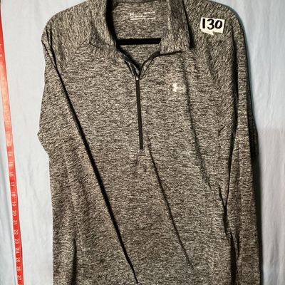 Sale Photo Thumbnail #31: Men's Under Armour HeatGear 1/4 zip long sleeve pullover shirt in heathered gray. Features a loose fit style and logo accents on the front chest and upper back. Size XL / TG / EG. Measures approximately 28.5 inches long. Appears in good pre-owned conditio