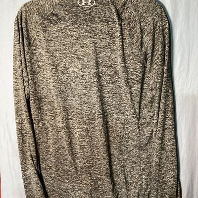 Sale Photo Thumbnail #33: Men's Under Armour HeatGear 1/4 zip long sleeve pullover shirt in heathered gray. Features a loose fit style and logo accents on the front chest and upper back. Size XL / TG / EG. Measures approximately 28.5 inches long. Appears in good pre-owned conditio
