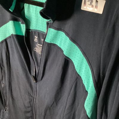 Sale Photo Thumbnail #36: Xersion brand Quick-Dri full-zip athletic jacket in black with teal/mint green perforated accent panels. Features front zip pockets and high collar. Made of 87% polyester and 13% spandex. Appears lightly used with no major flaws noted. Tag size 0X.