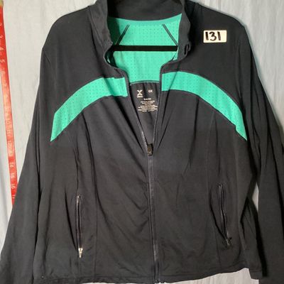 Sale Photo Thumbnail #34: Xersion brand Quick-Dri full-zip athletic jacket in black with teal/mint green perforated accent panels. Features front zip pockets and high collar. Made of 87% polyester and 13% spandex. Appears lightly used with no major flaws noted. Tag size 0X.