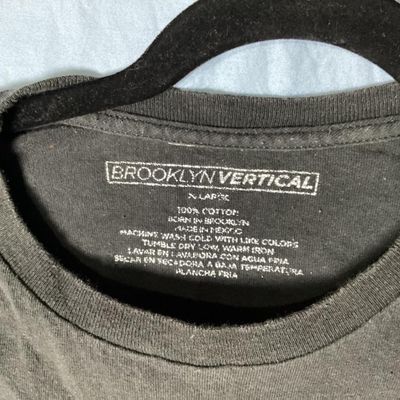 Sale Photo Thumbnail #40: Black Brooklyn Vertical short sleeve t-shirt featuring a graphic print of a bunny with an 'X' eye and red 'BAD' lettering. Made of 100% cotton in Mexico. Size XL. Length measures approximately 28.5 inches from top shoulder to bottom hem. Shows light wear 