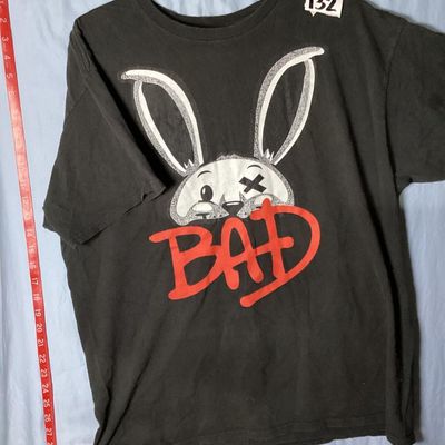 Sale Photo Thumbnail #38: Black Brooklyn Vertical short sleeve t-shirt featuring a graphic print of a bunny with an 'X' eye and red 'BAD' lettering. Made of 100% cotton in Mexico. Size XL. Length measures approximately 28.5 inches from top shoulder to bottom hem. Shows light wear 