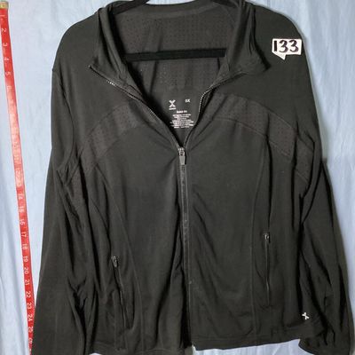 Sale Photo Thumbnail #42: Xersion brand women's black full-zip activewear jacket in size 0X. Features Quick-Dri moisture-wicking fabric, ventilated perforated panels across the upper chest and back, and front zipper pockets. Made of 88% polyester and 12% spandex. Appears lightly u