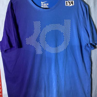 Sale Photo Thumbnail #48: Men's Nike short sleeve t-shirt featuring the Kevin Durant KD logo printed on the front. Features a two-tone blue and purple color block style design. Marked size XL (Athletic Cut). Gently used condition with light wear and minor wrinkling.