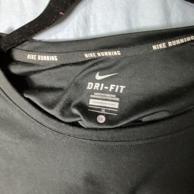 Sale Photo Thumbnail #63: Nike Running Dri-FIT short sleeve athletic top in black. Features small silver reflective Nike swoosh logo on front chest and reflective accent dots on the back. Tag size Women's 1X. Made in Thailand. Overall good pre-owned condition with light wear. Tota