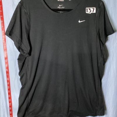 Sale Photo Thumbnail #61: Nike Running Dri-FIT short sleeve athletic top in black. Features small silver reflective Nike swoosh logo on front chest and reflective accent dots on the back. Tag size Women's 1X. Made in Thailand. Overall good pre-owned condition with light wear. Tota
