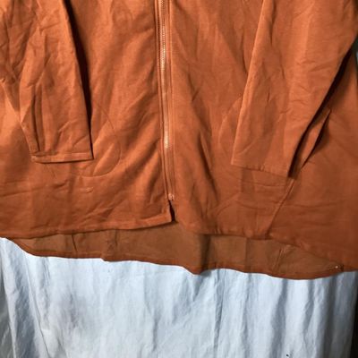 Sale Photo Thumbnail #69: LOGO Lounge by Lori Goldstein longline zip-up hoodie in a rust/terracotta shade. Features a hooded neckline with drawstring, front zip closure, front patch pockets, long sleeves, and a high-low hem. Lightly used condition with no visible damage or severe 
