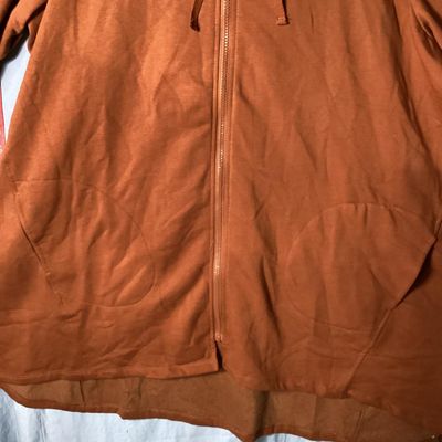 Sale Photo Thumbnail #70: LOGO Lounge by Lori Goldstein longline zip-up hoodie in a rust/terracotta shade. Features a hooded neckline with drawstring, front zip closure, front patch pockets, long sleeves, and a high-low hem. Lightly used condition with no visible damage or severe 