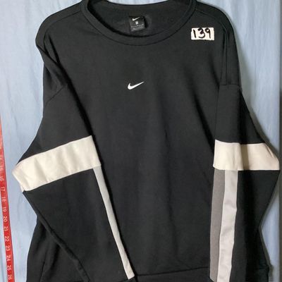 Sale Photo Thumbnail #71: Black Nike crewneck sweatshirt with embroidered center swoosh and white and grey color-blocked stripes on the sleeves. Tagged size XL made in Vietnam. Appears lightly used with no major flaws or visible damage.
