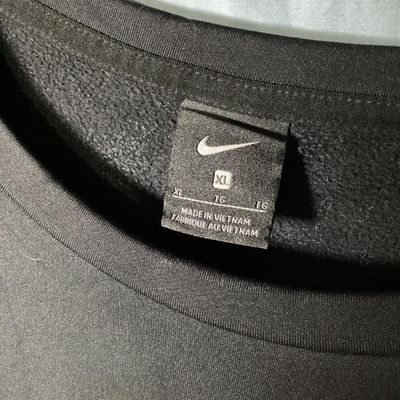 Sale Photo Thumbnail #75: Black Nike crewneck sweatshirt with embroidered center swoosh and white and grey color-blocked stripes on the sleeves. Tagged size XL made in Vietnam. Appears lightly used with no major flaws or visible damage.