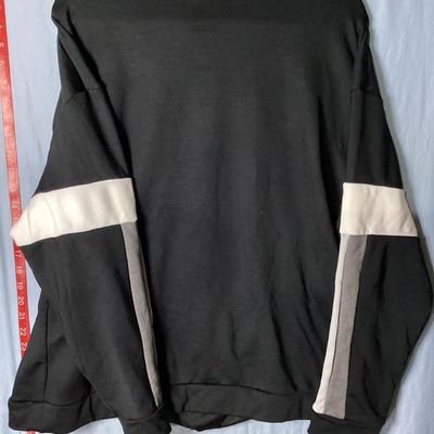 Sale Photo Thumbnail #76: Black Nike crewneck sweatshirt with embroidered center swoosh and white and grey color-blocked stripes on the sleeves. Tagged size XL made in Vietnam. Appears lightly used with no major flaws or visible damage.