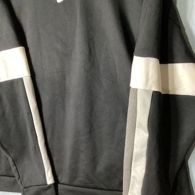 Sale Photo Thumbnail #72: Black Nike crewneck sweatshirt with embroidered center swoosh and white and grey color-blocked stripes on the sleeves. Tagged size XL made in Vietnam. Appears lightly used with no major flaws or visible damage.