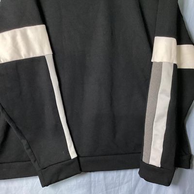 Sale Photo Thumbnail #74: Black Nike crewneck sweatshirt with embroidered center swoosh and white and grey color-blocked stripes on the sleeves. Tagged size XL made in Vietnam. Appears lightly used with no major flaws or visible damage.