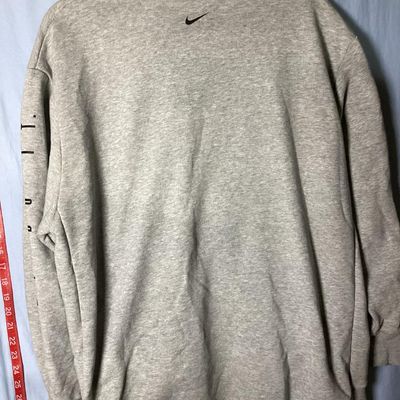 Sale Photo Thumbnail #87: Grey Nike Dri-FIT crewneck sweatshirt featuring 'JUST DO IT.' printed along the left sleeve and a small black Nike swoosh on the upper back. Tagged size XL (Extra Large). Shows light overall wear consistent with normal use, with no major stains or holes v