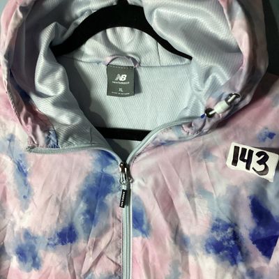 Sale Photo Thumbnail #92: New Balance hooded windbreaker/lightweight jacket featuring a pink, blue, and white tie-dye watercolor pattern. Includes full front zipper, zippered side pockets, mesh lining, hooded drawstrings, and an adjustable cinch hemline. Size XL. Made in Vietnam. 