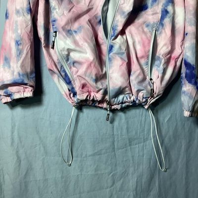 Sale Photo Thumbnail #96: New Balance hooded windbreaker/lightweight jacket featuring a pink, blue, and white tie-dye watercolor pattern. Includes full front zipper, zippered side pockets, mesh lining, hooded drawstrings, and an adjustable cinch hemline. Size XL. Made in Vietnam. 