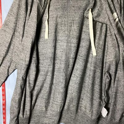 Sale Photo Thumbnail #116: Nike heather gray full-zip hooded sweatshirt featuring white 'Nike Just Do It' logo on the chest. Has front hand pockets, drawstring hood, and raglan sleeves. Tag size XXL (1XG/2EG). Lightly worn in good pre-owned condition with no major stains, rips, or 