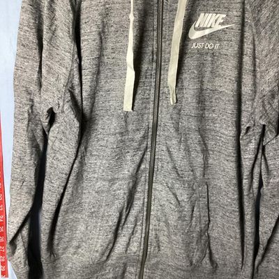 Sale Photo Thumbnail #113: Nike heather gray full-zip hooded sweatshirt featuring white 'Nike Just Do It' logo on the chest. Has front hand pockets, drawstring hood, and raglan sleeves. Tag size XXL (1XG/2EG). Lightly worn in good pre-owned condition with no major stains, rips, or 