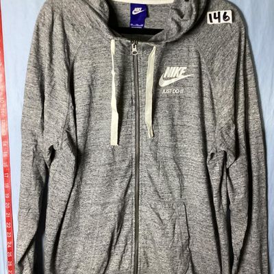 Sale Photo Thumbnail #110: Nike heather gray full-zip hooded sweatshirt featuring white 'Nike Just Do It' logo on the chest. Has front hand pockets, drawstring hood, and raglan sleeves. Tag size XXL (1XG/2EG). Lightly worn in good pre-owned condition with no major stains, rips, or 