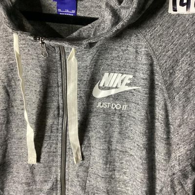 Sale Photo Thumbnail #111: Nike heather gray full-zip hooded sweatshirt featuring white 'Nike Just Do It' logo on the chest. Has front hand pockets, drawstring hood, and raglan sleeves. Tag size XXL (1XG/2EG). Lightly worn in good pre-owned condition with no major stains, rips, or 