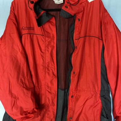 Sale Photo Thumbnail #123: Red and dark gray Columbia Sportswear Company hooded windbreaker/rain jacket. Features full zip front with snap closure overlay, mesh lining, hood with drawstring, and side pockets. Women's size XL, made in Philippines. Light wear visible, overall good pr