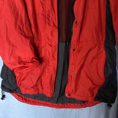Sale Photo Thumbnail #125: Red and dark gray Columbia Sportswear Company hooded windbreaker/rain jacket. Features full zip front with snap closure overlay, mesh lining, hood with drawstring, and side pockets. Women's size XL, made in Philippines. Light wear visible, overall good pr