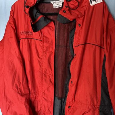Sale Photo Thumbnail #127: Red and dark gray Columbia Sportswear Company hooded windbreaker/rain jacket. Features full zip front with snap closure overlay, mesh lining, hood with drawstring, and side pockets. Women's size XL, made in Philippines. Light wear visible, overall good pr