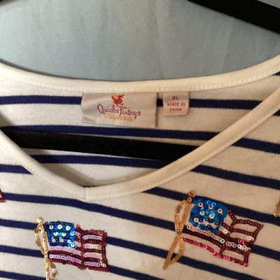Sale Photo Thumbnail #133: Women's Quacker Factory by Jeanne Bice v-neck top featuring navy blue and white horizontal stripes with sequined American flag embellishments across the chest and shoulders. 3/4 length sleeves. Size XL. Made in China. In good pre-owned condition with no v