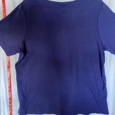 Sale Photo Thumbnail #139: Quacker Factory short sleeve V-neck top in blue, featuring a embellished American flag design on the chest with colorful rhinestones and studs. Tagged size XL. Made in China. Measures approximately 28 inches in length from shoulder to hem. Good pre-owned 