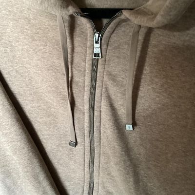Sale Photo Thumbnail #143: An Isaac Mizrahi Live! women's full-zip fleece hooded sweatshirt/jacket in heathered tan/light brown. Features a drawstring hood with bright pink inner neck tape, front patch pockets, silver-tone hardware with engraved logo toggles, and side slits at the 