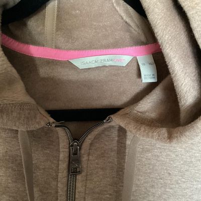 Sale Photo Thumbnail #141: An Isaac Mizrahi Live! women's full-zip fleece hooded sweatshirt/jacket in heathered tan/light brown. Features a drawstring hood with bright pink inner neck tape, front patch pockets, silver-tone hardware with engraved logo toggles, and side slits at the 