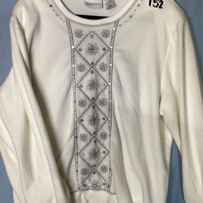 Sale Photo Thumbnail #146: An Alfred Dunner long-sleeve fleece sweatshirt in cream/white, featuring intricate floral embroidery, sequins, and bead accents along the front panel. Made from 100% polyester. Size XL. Appears to be in good pre-owned condition with minor signs of wear.