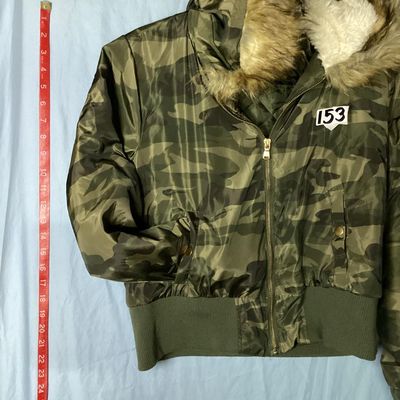 Sale Photo Thumbnail #153: Rue21 camouflage print bomber jacket featuring a faux fur trimmed, sherpa-lined hood, quilted inner lining, full zip front, and rib-knit waist trim and cuffs. Includes side pockets with snap closures and a zippered sleeve pocket. Size Large. Made in China