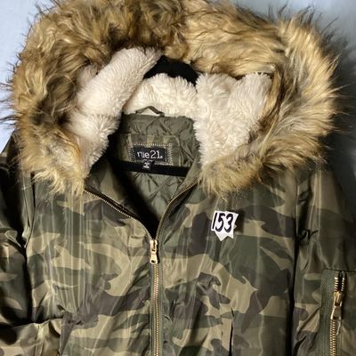 Sale Photo Thumbnail #154: Rue21 camouflage print bomber jacket featuring a faux fur trimmed, sherpa-lined hood, quilted inner lining, full zip front, and rib-knit waist trim and cuffs. Includes side pockets with snap closures and a zippered sleeve pocket. Size Large. Made in China