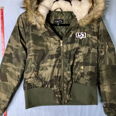 Sale Photo Thumbnail #152: Rue21 camouflage print bomber jacket featuring a faux fur trimmed, sherpa-lined hood, quilted inner lining, full zip front, and rib-knit waist trim and cuffs. Includes side pockets with snap closures and a zippered sleeve pocket. Size Large. Made in China