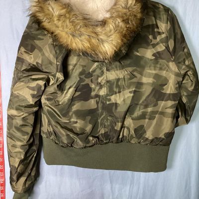 Sale Photo Thumbnail #156: Rue21 camouflage print bomber jacket featuring a faux fur trimmed, sherpa-lined hood, quilted inner lining, full zip front, and rib-knit waist trim and cuffs. Includes side pockets with snap closures and a zippered sleeve pocket. Size Large. Made in China