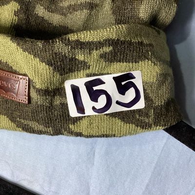 Sale Photo Thumbnail #167: New with tags Levi's knit beanie hat featuring a green camo pattern with a faux leather Levi's logo patch on the front cuff. Tag shows style 45LP050015, color Camouflage,  One Size.Material is knit fabric. New condition with original retail tag attached.