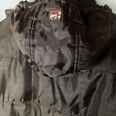 Sale Photo Thumbnail #198: Men's Phat Farm Classics hooded puffer jacket in black, size XL. Features a full zip front, detachable or adjustable hood, embroidered logo crest on the left chest, and subtle logo pattern printed across the shell fabric. Condition shows light wear, inclu