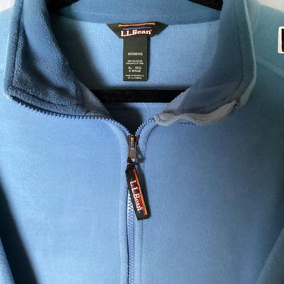 Sale Photo Thumbnail #200: L.L. Bean women's full-zip fleece jacket in light blue. Features front zippered pockets, high collar, interior cinch waist adjustment, and branded zipper pull. 

- Brand: L.L. Bean
- Size: Women's XL - Regular
- Material: 100% Polyester
- Color: Light Blu