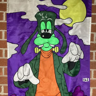 Sale Photo Thumbnail #211: Large vintage fabric/nylon decorative Halloween door or wall banner featuring Disney's Goofy dressed as Frankenstein's monster under a full moon. Fabric appliqué construction with embroidered black outline stitching. Measures approximately 75 inches long