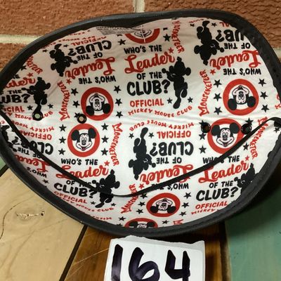 Sale Photo Thumbnail #226: Black felt Mickey Mouse ear hat featuring a front Walt Disney World patch with Mickey Mouse graphics. The interior lining is decorated with printed Mickey Mouse Club graphics. Comes with an elastic chin strap. Pre-owned condition with minor surface dust/f