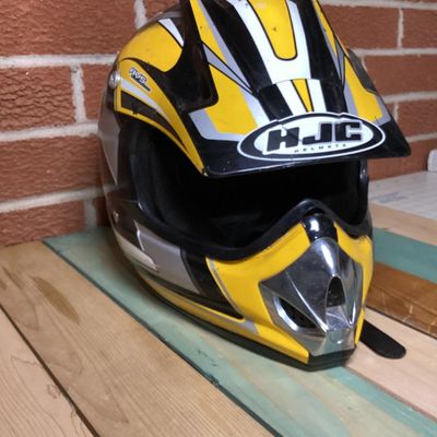 Sale Photo Thumbnail #234: HJC CL-X4 Fuel off-road/motocross motorcycle helmet in yellow, silver, black, and white graphics. Marked as Adult Large size with Advanced Ventilation System (AVS). Inner label indicates manufacturing date of September 2001. Features visor, chin guard ven