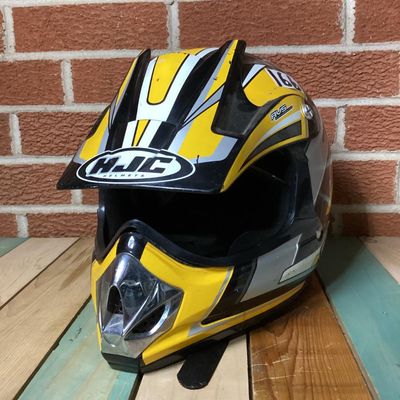 Sale Photo Thumbnail #238: HJC CL-X4 Fuel off-road/motocross motorcycle helmet in yellow, silver, black, and white graphics. Marked as Adult Large size with Advanced Ventilation System (AVS). Inner label indicates manufacturing date of September 2001. Features visor, chin guard ven